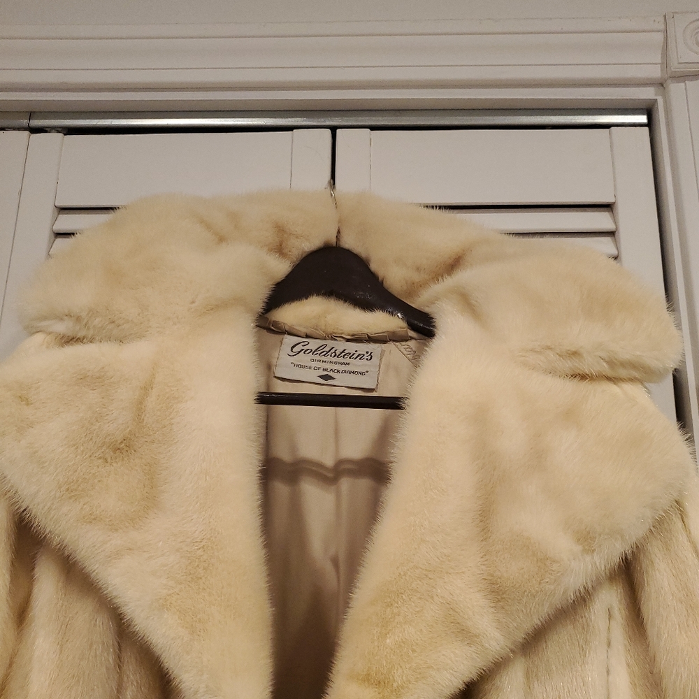 Genuine white mink coat with white leather inserts.